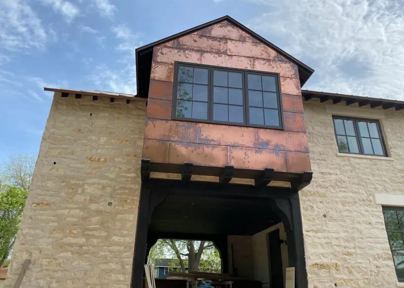 Copper metal panel facade on a stone building for Metal Roof Coating in King
